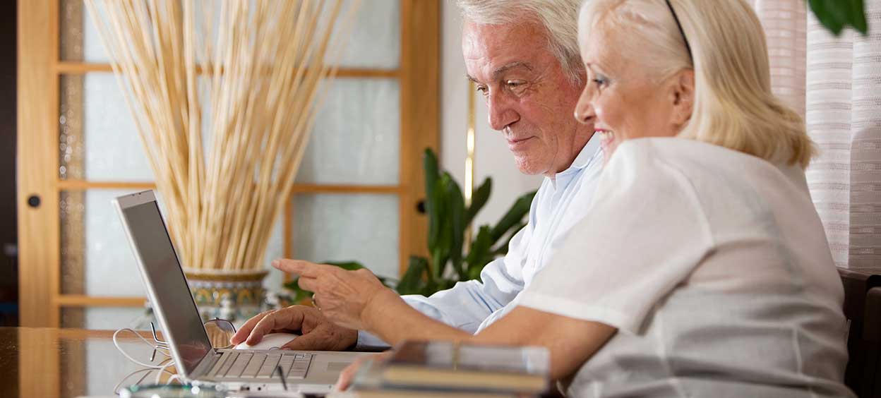 Senior couple with computer